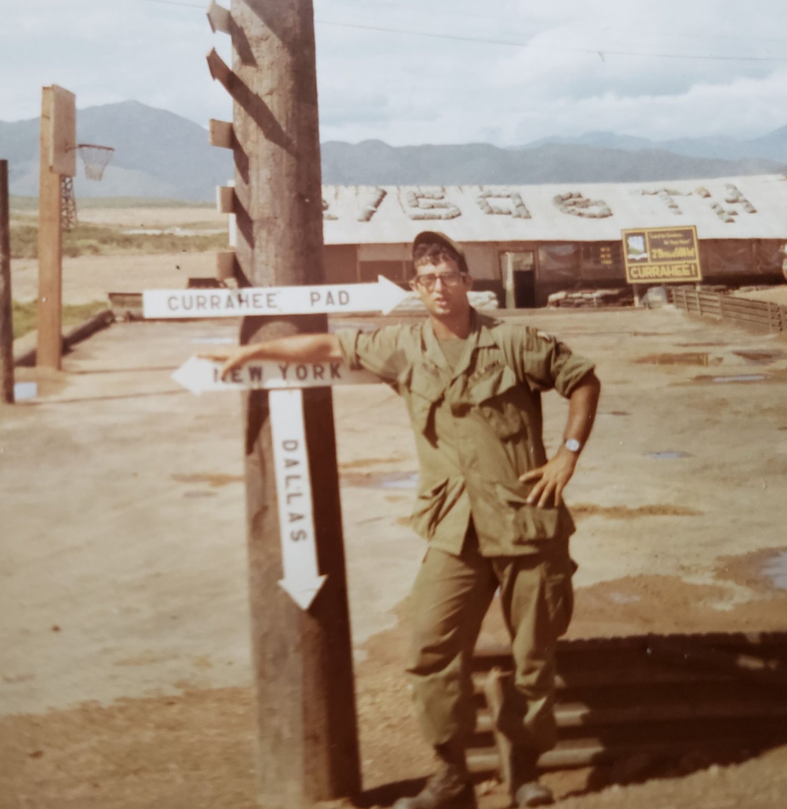 Pete Meloro at the Currahee Pad directional sign, Camp Evans, Vietnam
